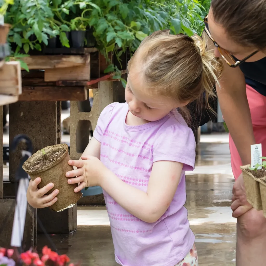 mom and child shopping for plants in cowpots